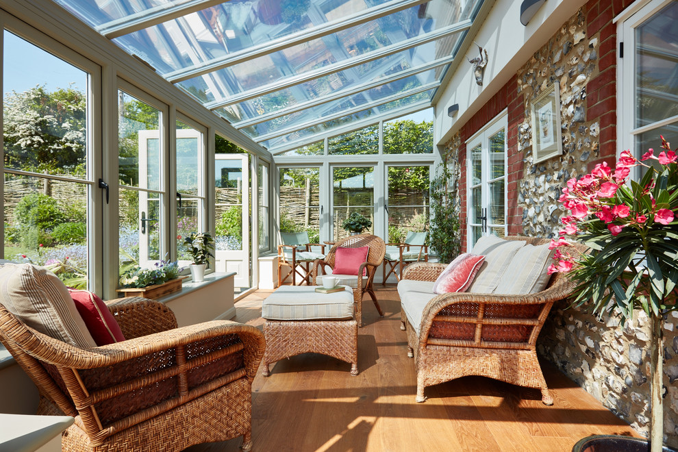 Inspiration for a small traditional sunroom in Other with medium hardwood floors, a glass ceiling and no fireplace.