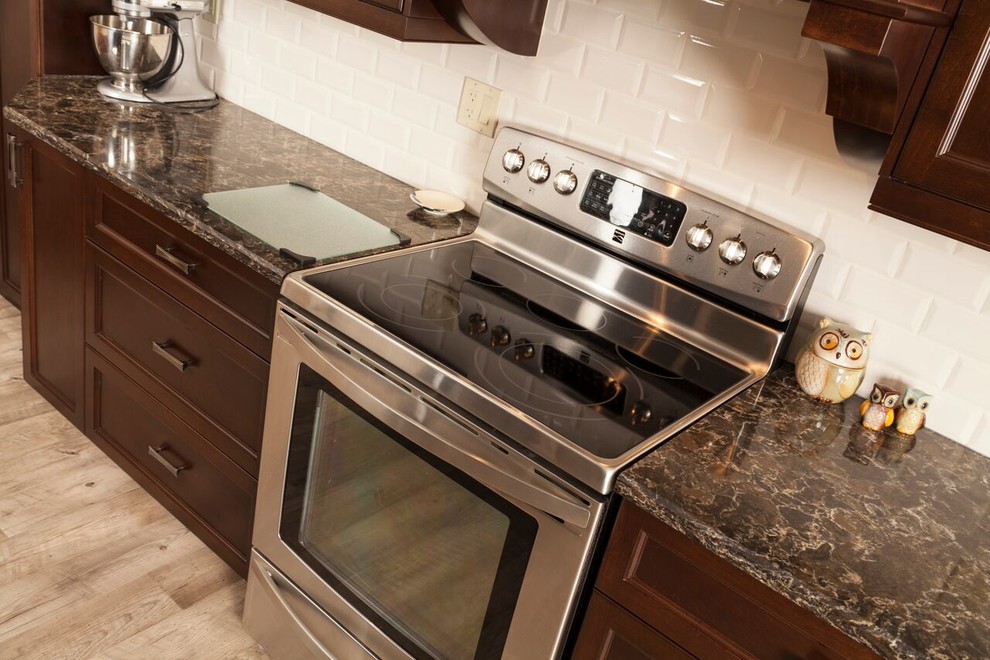 Example of a transitional kitchen design in Toronto with shaker cabinets, dark wood cabinets, granite countertops, white backsplash, subway tile backsplash and stainless steel appliances