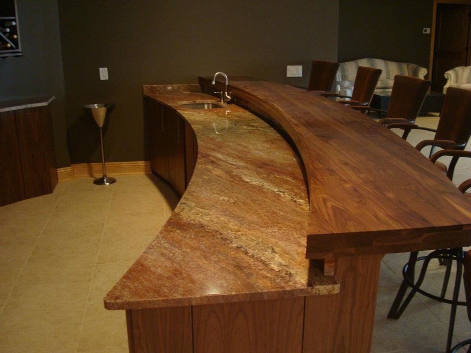Photo of a mid-sized midcentury seated home bar in Cleveland with marble benchtops and ceramic floors.