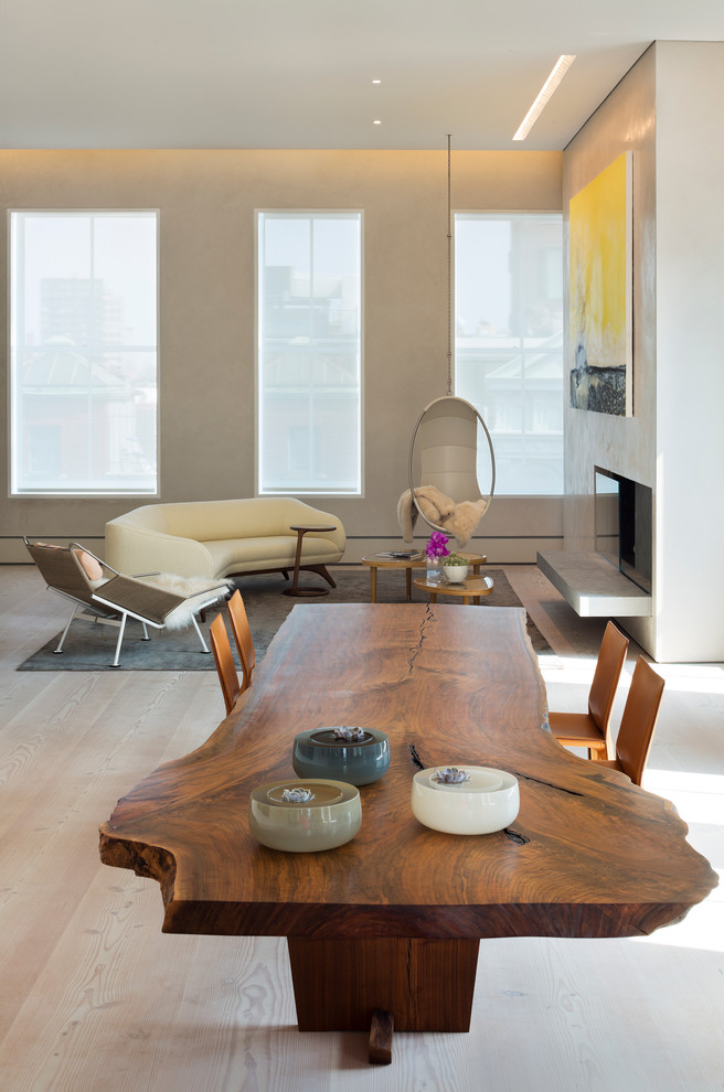Contemporary open plan dining in New York with beige walls and light hardwood floors.