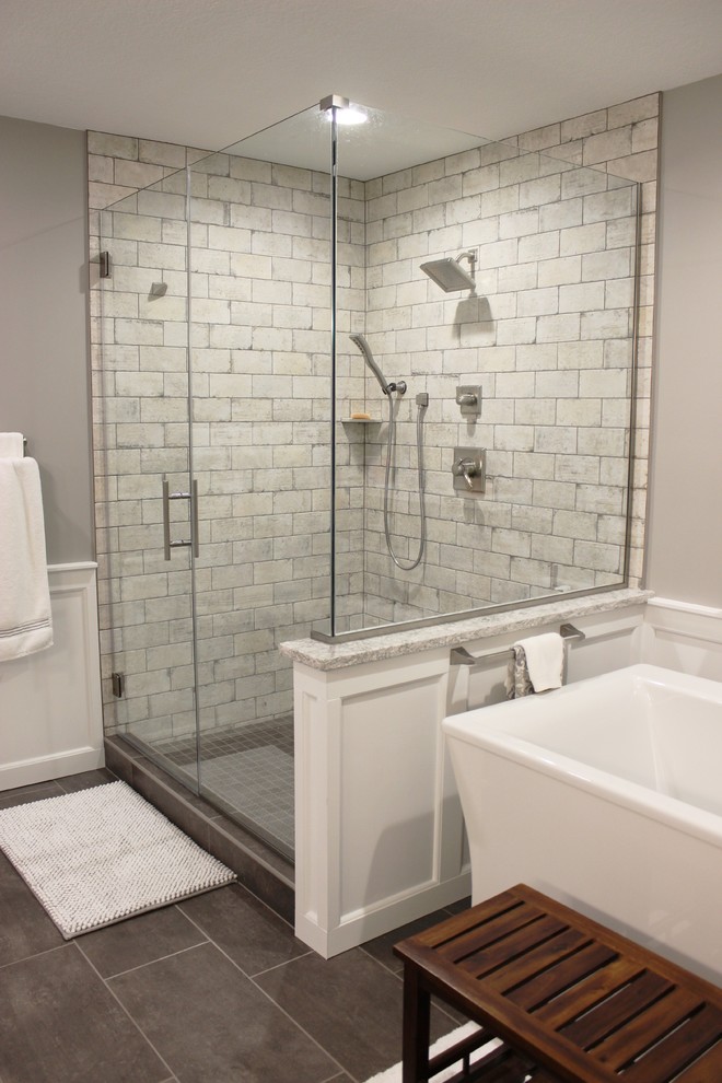 Inspiration for a large transitional master bathroom in Other with white cabinets, a freestanding tub, a corner shower, beige tile, porcelain tile, grey walls, porcelain floors, an undermount sink, engineered quartz benchtops, grey floor, a hinged shower door and beige benchtops.