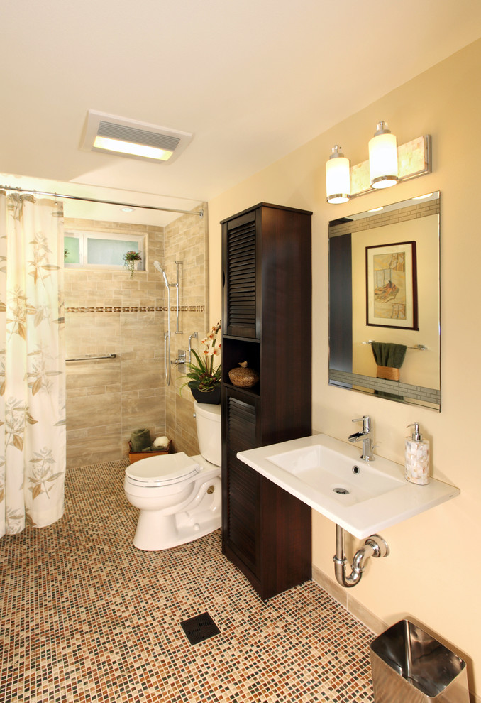 Design ideas for a mid-sized traditional 3/4 bathroom in Los Angeles with louvered cabinets, dark wood cabinets, a curbless shower, a two-piece toilet, porcelain tile, beige walls, mosaic tile floors, a wall-mount sink, beige floor and a shower curtain.