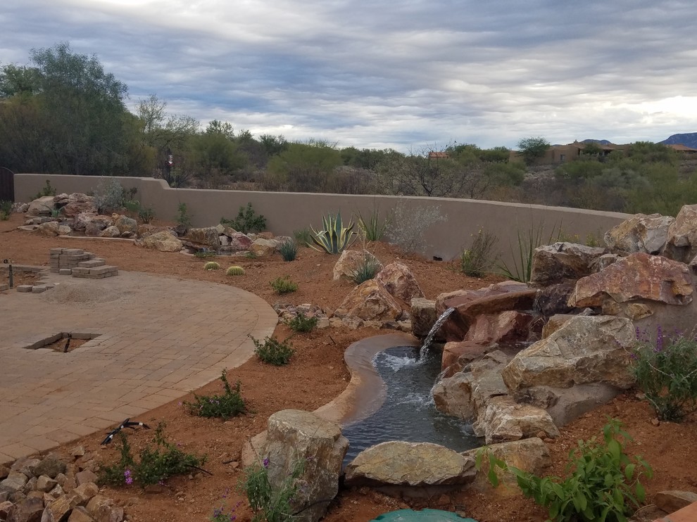 Photo of a large backyard full sun xeriscape in Phoenix with a fire feature and brick pavers.