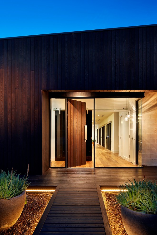 Large contemporary front door in Melbourne with a single front door and a dark wood front door.