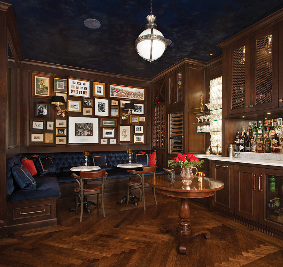 Example of a large classic single-wall dark wood floor and brown floor seated home bar design in Toronto with an undermount sink, recessed-panel cabinets, dark wood cabinets, marble countertops and white countertops