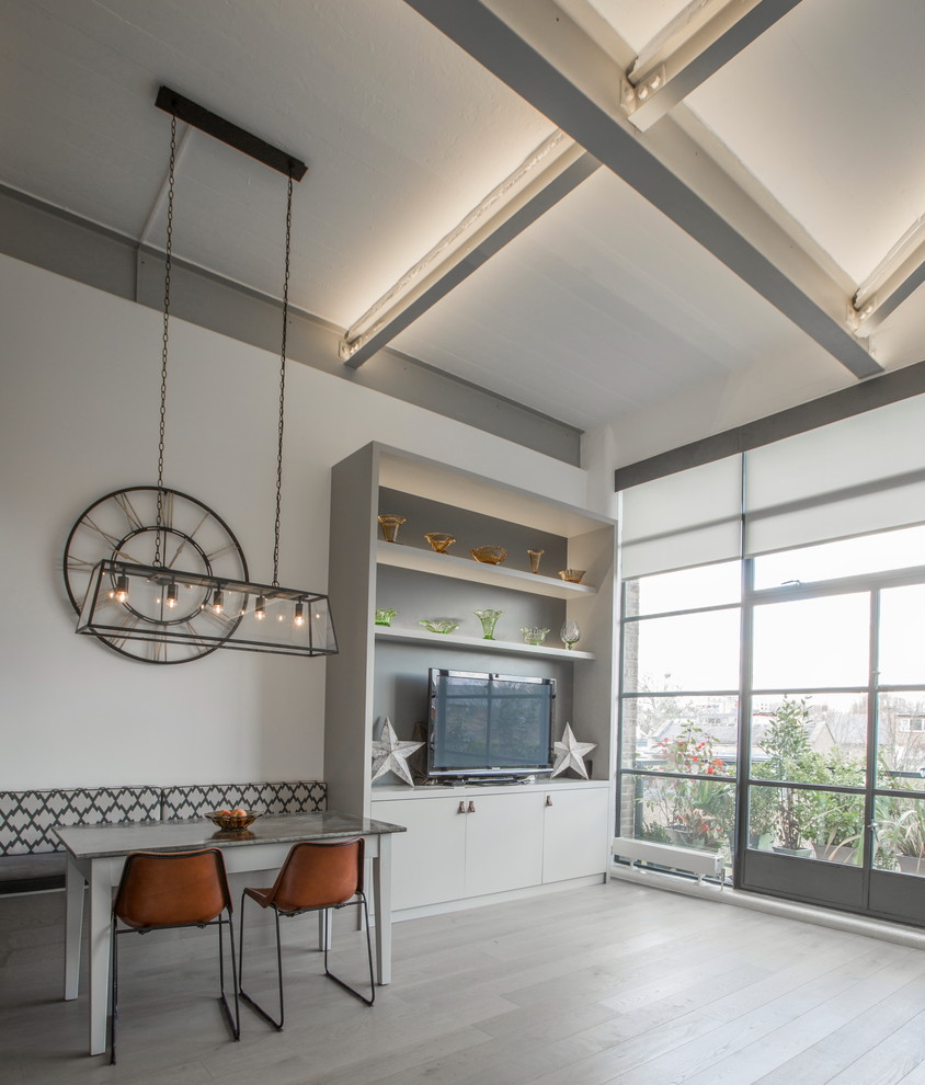 Design ideas for a medium sized industrial mezzanine living room in London with white walls, light hardwood flooring and a built-in media unit.