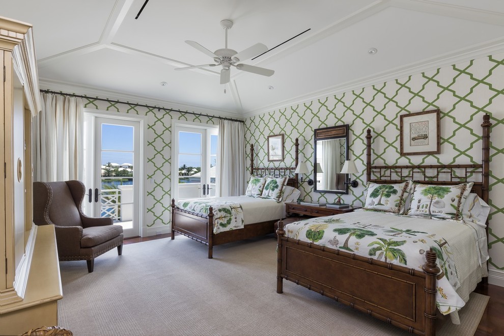 Photo of a tropical guest bedroom in Miami with multi-coloured walls and medium hardwood floors.