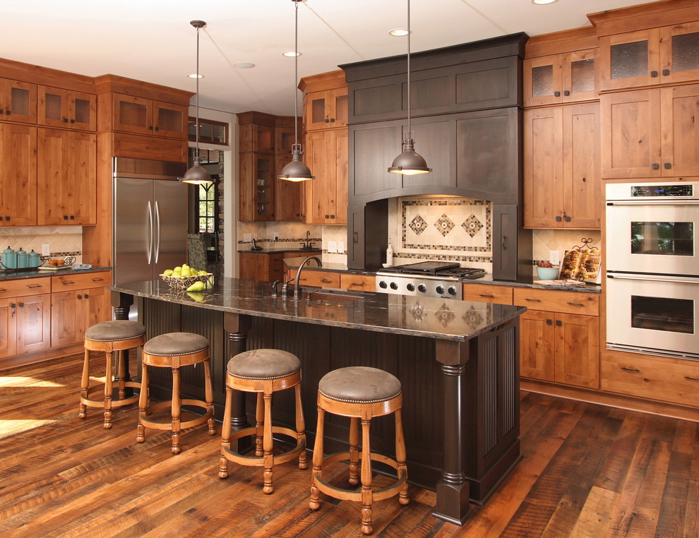 Inspiration for a traditional l-shaped eat-in kitchen in Raleigh with a single-bowl sink, flat-panel cabinets, medium wood cabinets, granite benchtops, beige splashback, stone tile splashback and stainless steel appliances.