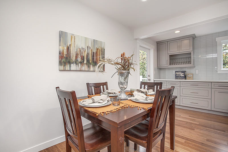 Kitchen/dining room combo - transitional medium tone wood floor kitchen/dining room combo idea in Seattle