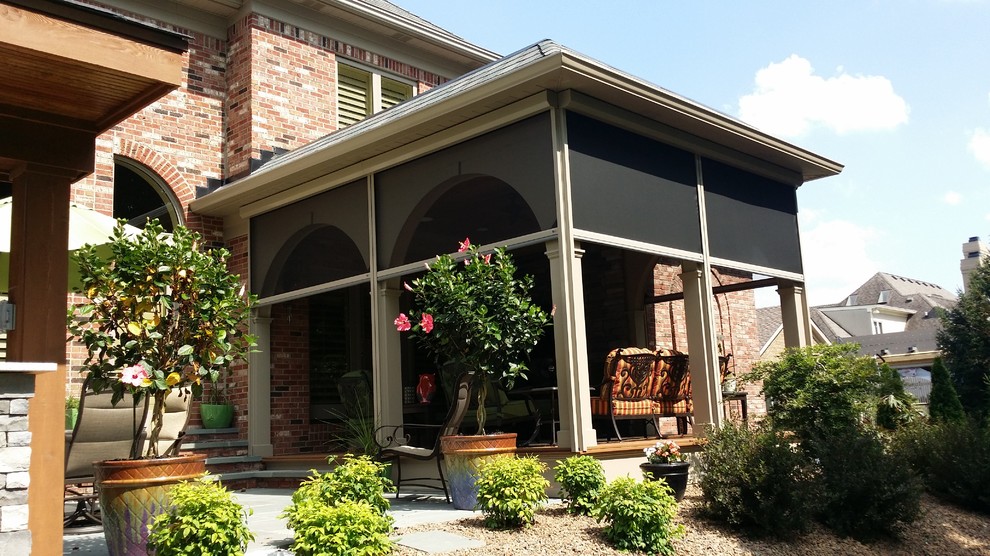 Photo of a large traditional backyard screened-in verandah in Orange County with a roof extension and decking.