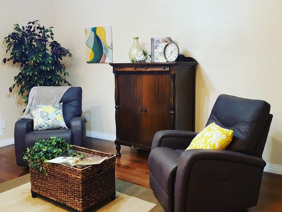 Example of a mid-sized trendy formal and enclosed dark wood floor and brown floor living room design in Sacramento with brown walls and no fireplace