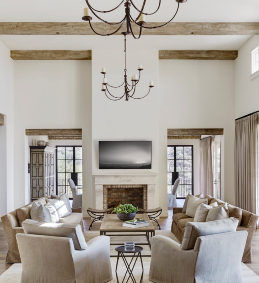 Large contemporary open concept living room in Phoenix with white walls, medium hardwood floors, a standard fireplace, a stone fireplace surround, a wall-mounted tv and brown floor.