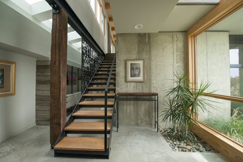 This is an example of a mid-sized industrial wood straight staircase in Philadelphia with open risers.