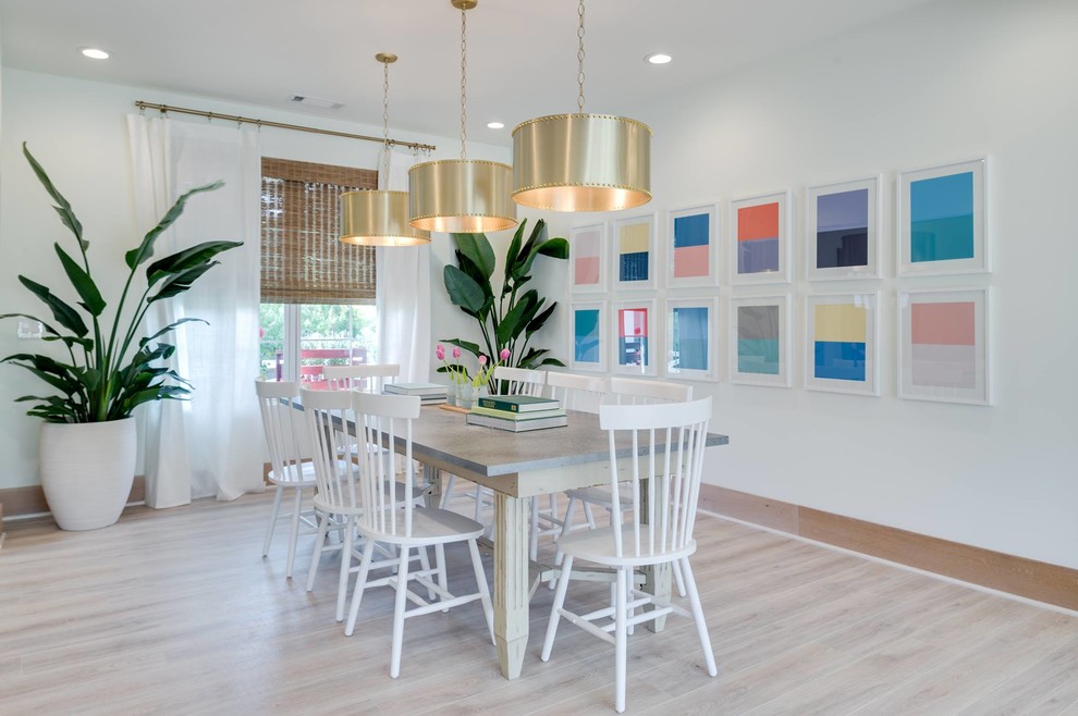 Enclosed dining room - transitional light wood floor enclosed dining room idea in Orange County with white walls