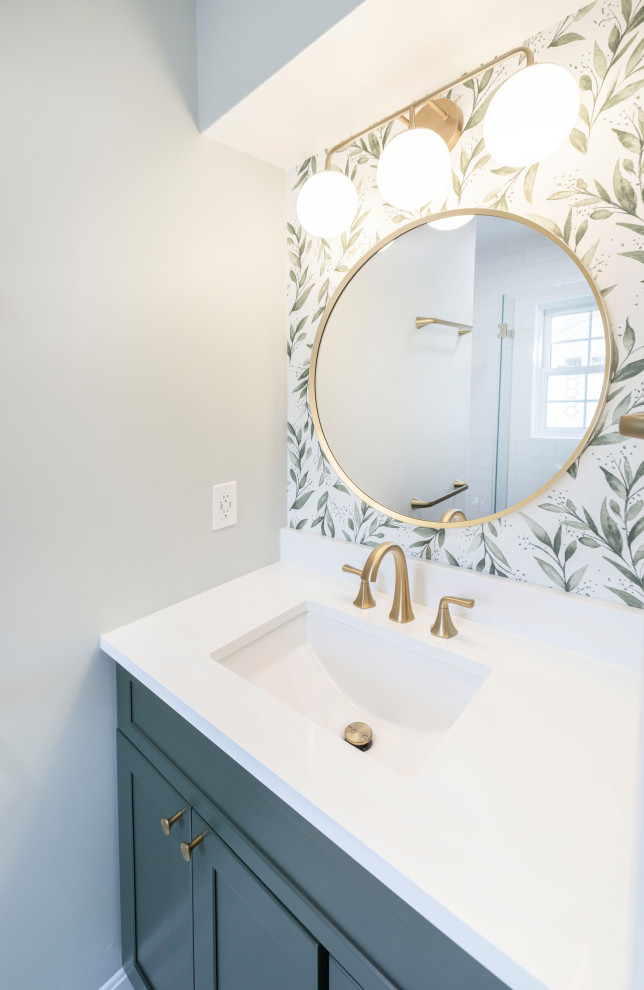 Photo of a mid-sized contemporary master bathroom in DC Metro with shaker cabinets, green cabinets, an alcove shower, white tile, ceramic tile, green walls, marble floors, an undermount sink, engineered quartz benchtops, green floor, a hinged shower door, white benchtops, a niche, a single vanity, a built-in vanity and wallpaper.