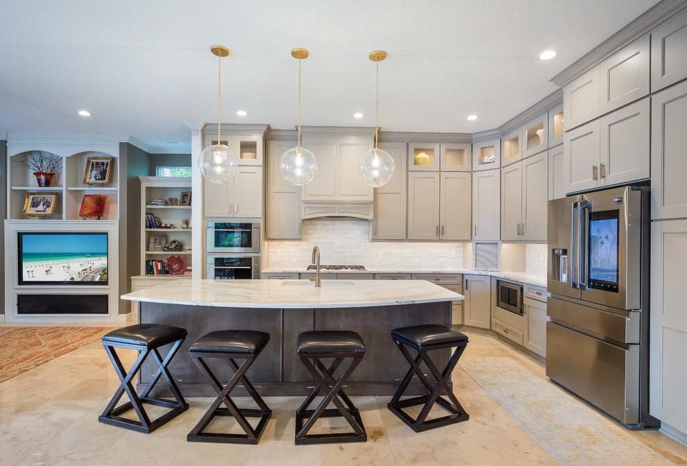 Mid-sized transitional l-shaped eat-in kitchen in Jacksonville with an undermount sink, recessed-panel cabinets, quartz benchtops, white splashback, marble splashback, stainless steel appliances, with island, white benchtop, beige cabinets, marble floors and beige floor.
