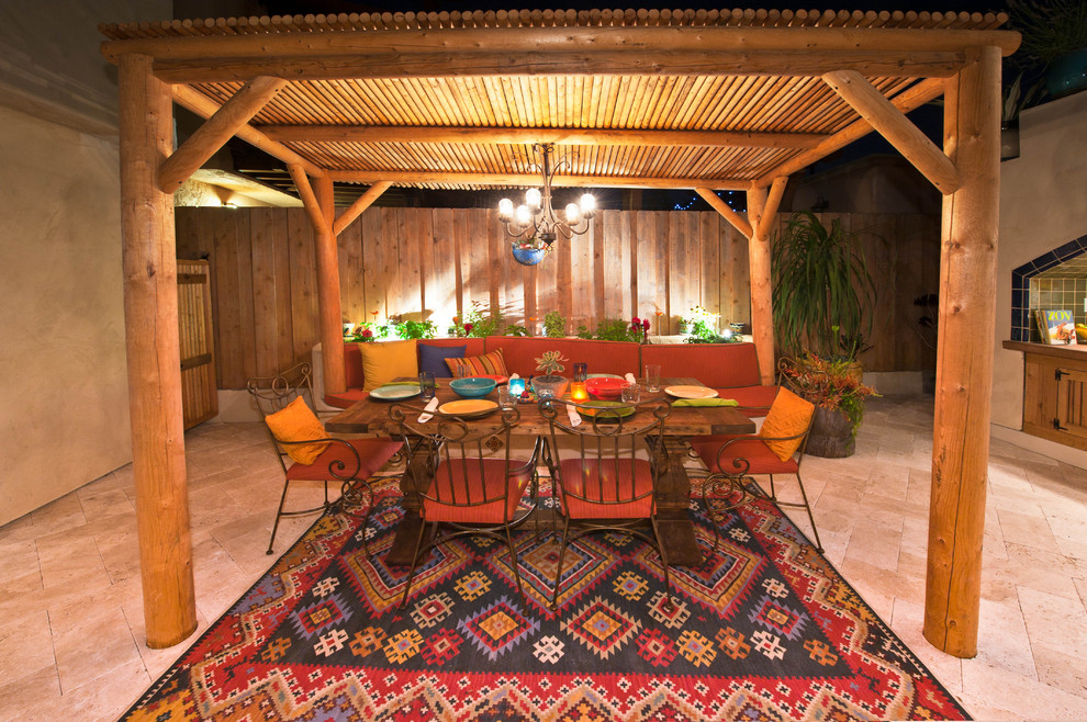 Expansive eclectic backyard patio in San Diego with an outdoor kitchen, natural stone pavers and a pergola.