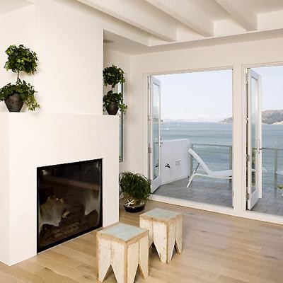 Modern living room in San Francisco with a standard fireplace and a plaster fireplace surround.