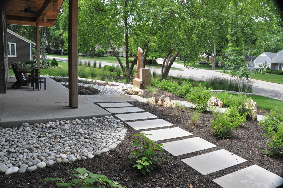 Inspiration for a large contemporary front yard full sun xeriscape in Kansas City with a garden path and concrete pavers.