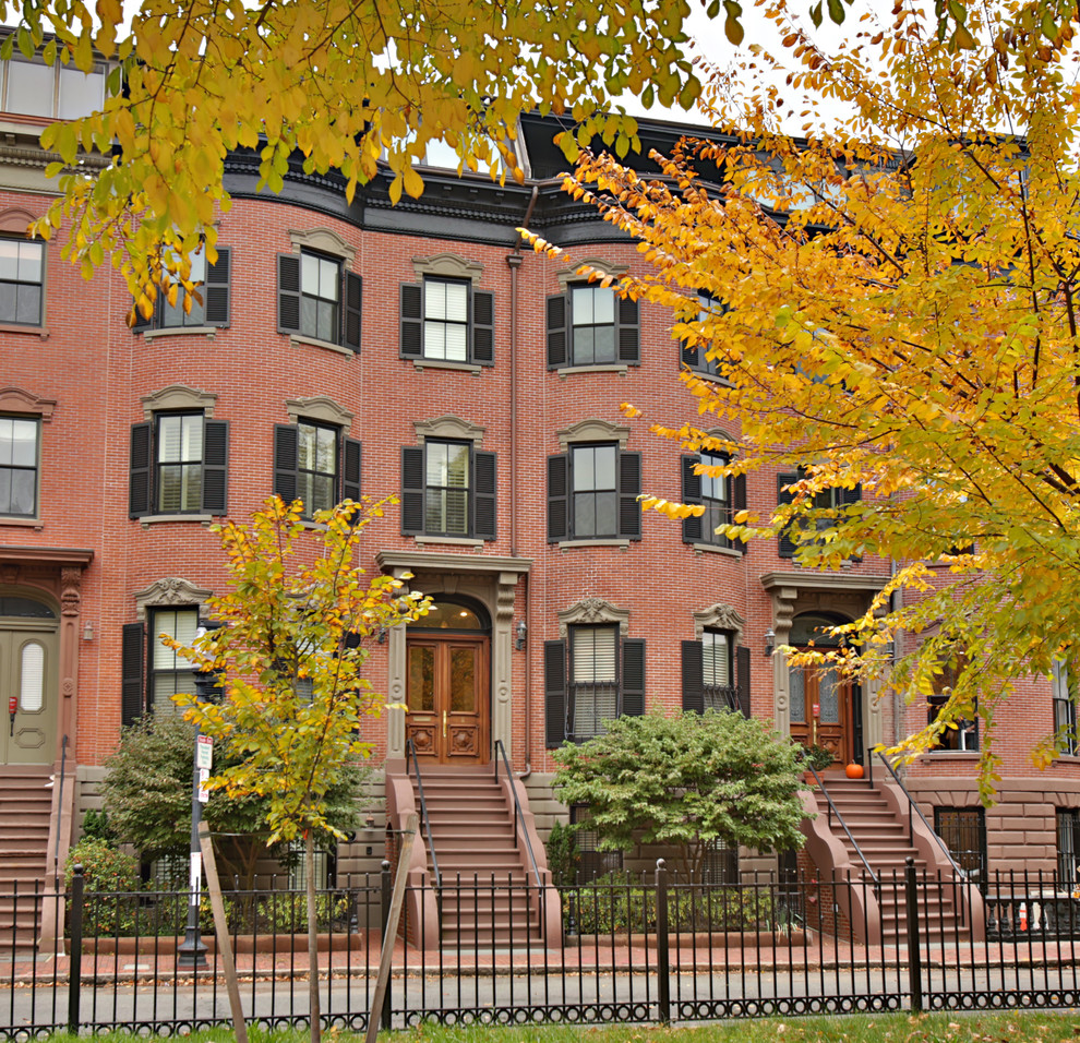 This is an example of a mid-sized midcentury one-storey brick red exterior in Boston.
