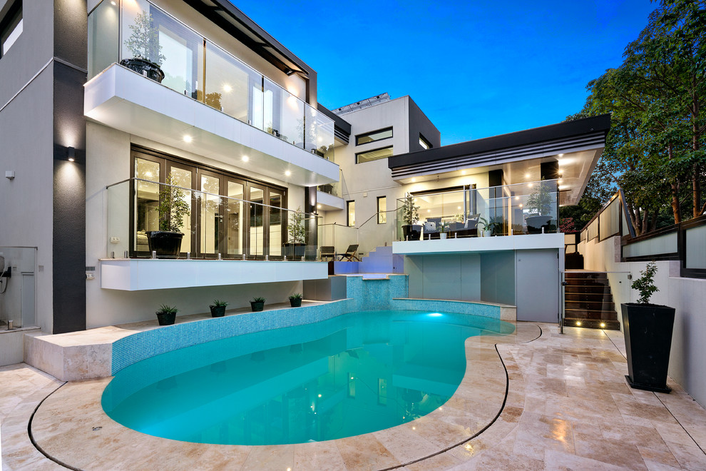 Contemporary backyard custom-shaped natural pool in Melbourne.