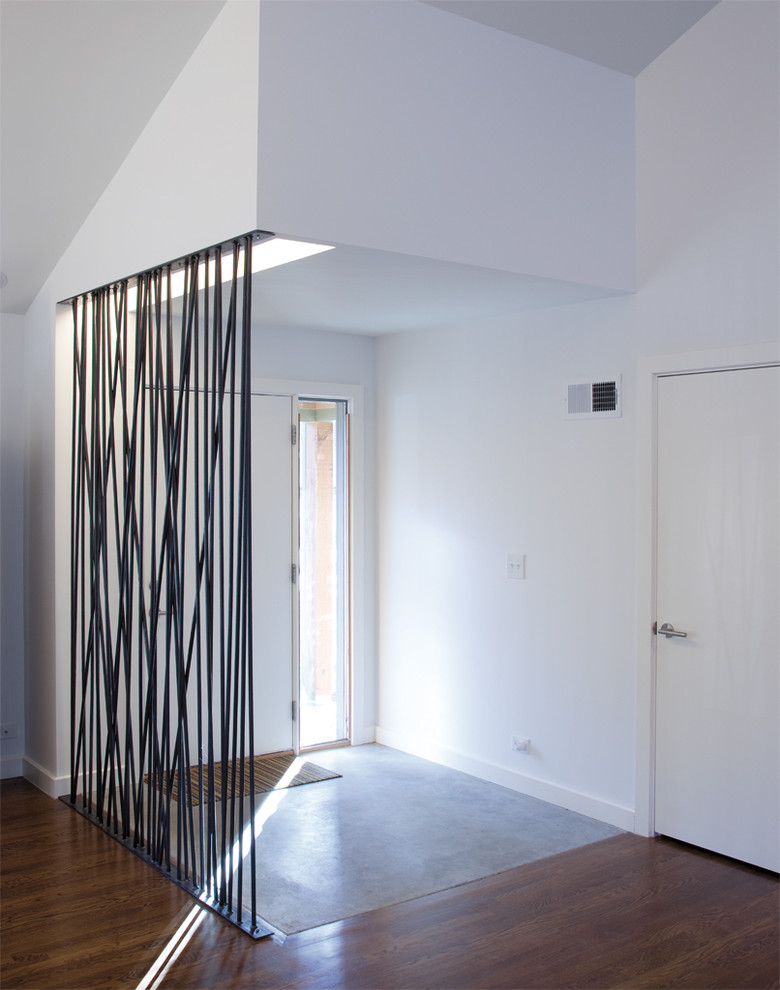 Inspiration for a midcentury vestibule in Kansas City with white walls.