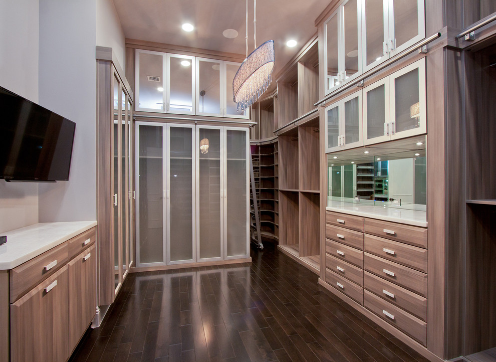 Photo of an expansive transitional women's walk-in wardrobe in Miami with raised-panel cabinets, dark wood cabinets and dark hardwood floors.