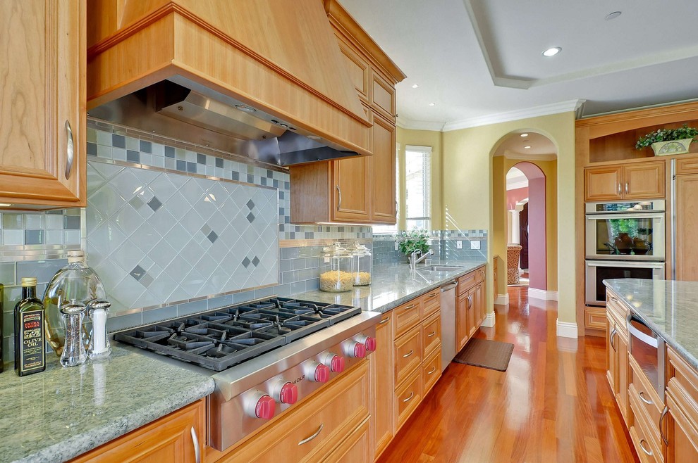 Photo of a traditional kitchen in San Francisco with stainless steel appliances and turquoise benchtop.