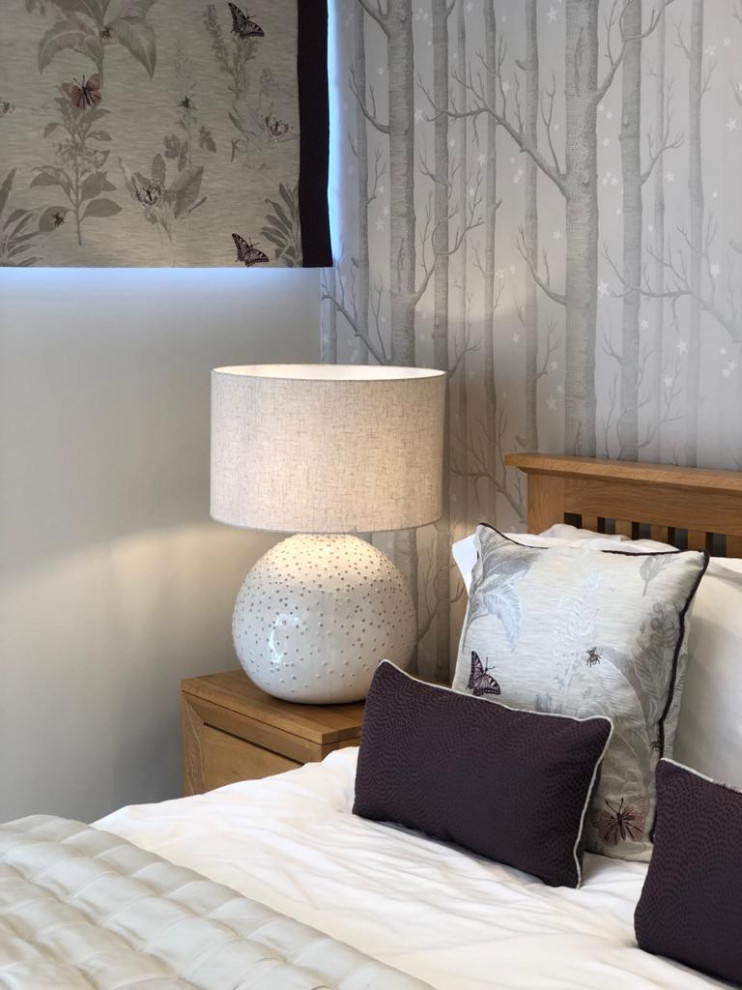 Design ideas for a contemporary guest bedroom in Berkshire with grey walls and wallpaper.