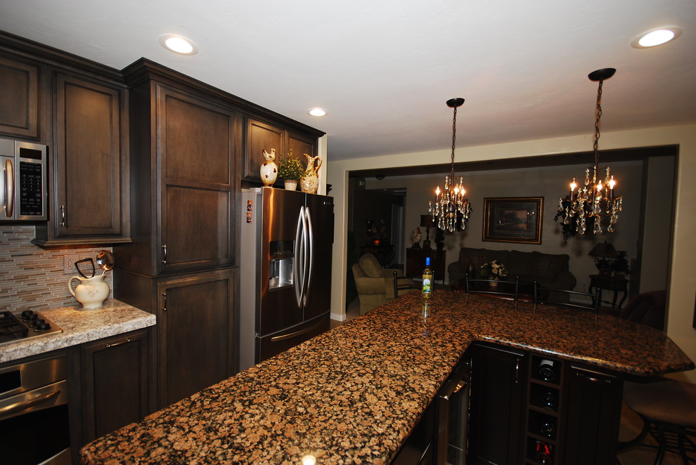 Mid-sized transitional u-shaped porcelain tile open concept kitchen photo with an undermount sink, flat-panel cabinets, gray cabinets, quartz countertops, gray backsplash, stainless steel appliances and an island