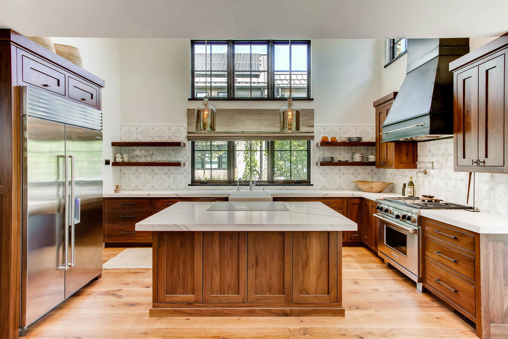 Inspiration for a timeless u-shaped medium tone wood floor and brown floor kitchen remodel in Denver with a farmhouse sink, shaker cabinets, medium tone wood cabinets, stainless steel appliances and an island
