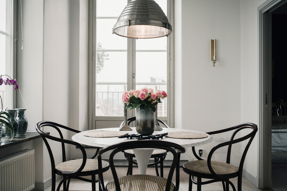 This is an example of a scandinavian separate dining room in Stockholm with white walls and no fireplace.
