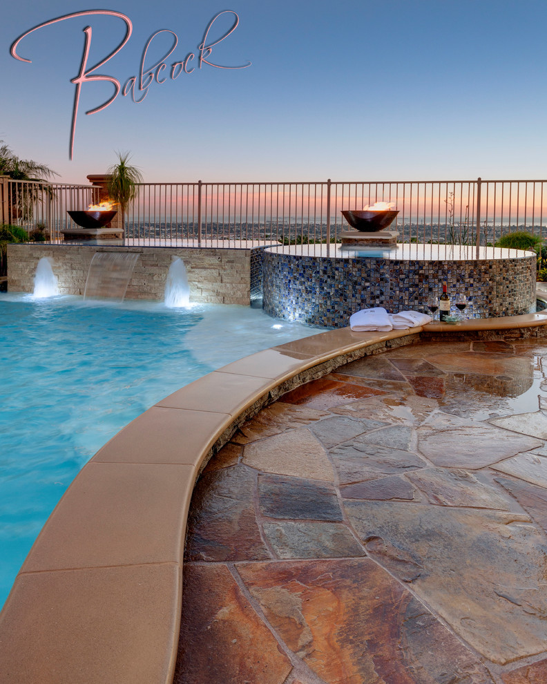 Tuscan backyard custom-shaped infinity pool photo in Los Angeles