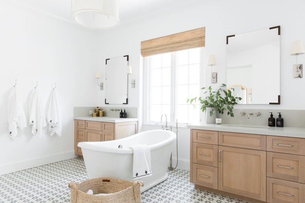 Large transitional master bathroom in Salt Lake City with shaker cabinets, light wood cabinets, a freestanding tub, an alcove shower, white tile, white walls, ceramic floors, a drop-in sink, multi-coloured floor and a hinged shower door.
