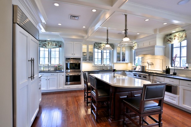 Kitchen with white cabinets and coffered ceiling ...