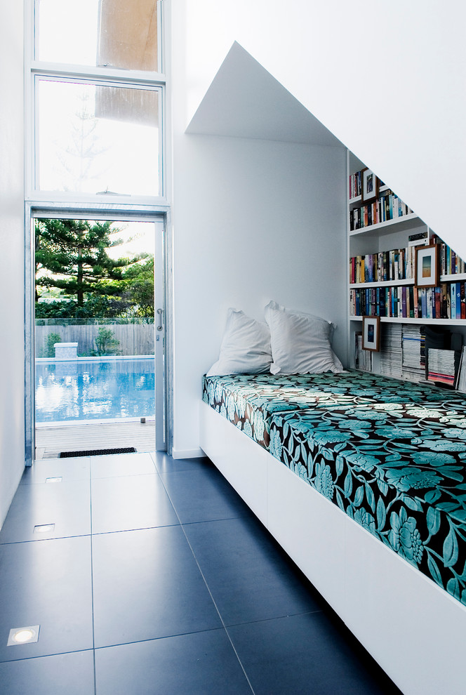 Photo of a contemporary family room in Sunshine Coast with a library and white walls.