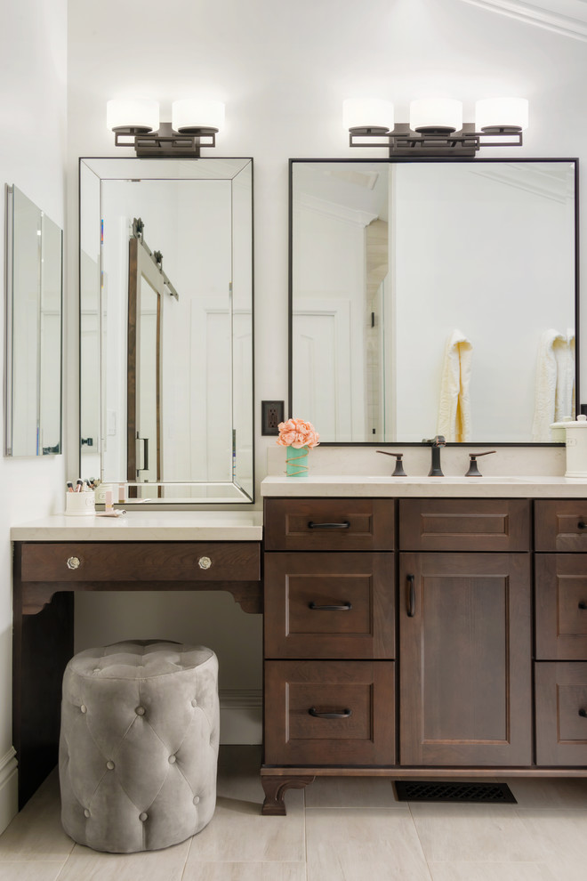 Design ideas for a mid-sized traditional master bathroom in San Francisco with brown cabinets, an alcove shower, a one-piece toilet, porcelain floors, engineered quartz benchtops, beige floor, a hinged shower door, shaker cabinets, white walls and an undermount sink.