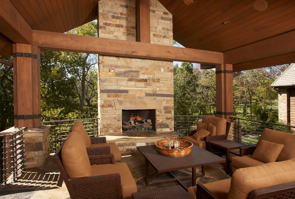 This is an example of a large contemporary deck in Kansas City with a fire feature.