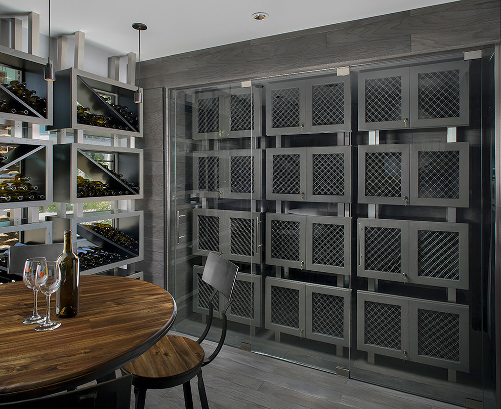 Photo of a mid-sized contemporary wine cellar in Phoenix with storage racks, painted wood floors and grey floor.