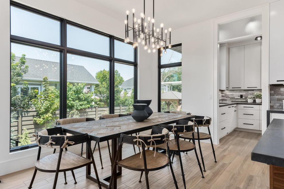 This is an example of a large contemporary kitchen/dining combo in Salt Lake City with porcelain floors, beige floor and white walls.