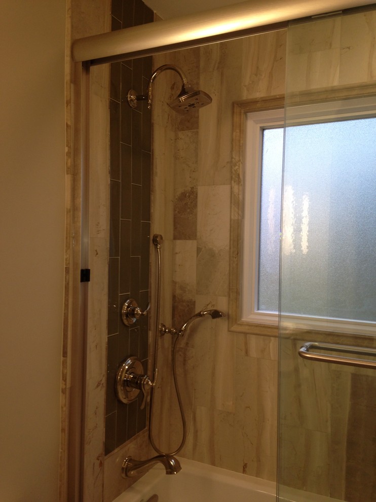 Inspiration for a transitional beige tile and stone tile marble floor alcove bathtub remodel with a vessel sink, flat-panel cabinets, white cabinets, quartzite countertops and beige walls