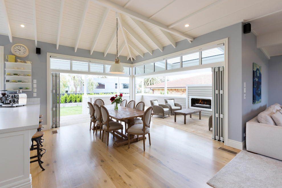 Design ideas for a traditional open plan dining in Auckland with grey walls, medium hardwood floors and no fireplace.