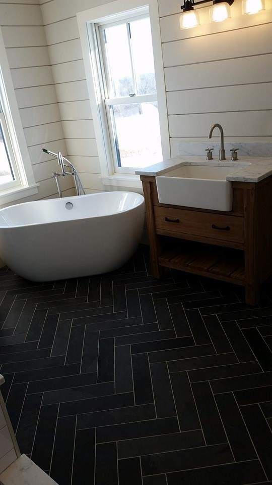 Design ideas for a mid-sized country master bathroom in Burlington with furniture-like cabinets, medium wood cabinets, a freestanding tub, a two-piece toilet, black and white tile, stone tile, beige walls, slate floors, an integrated sink and marble benchtops.