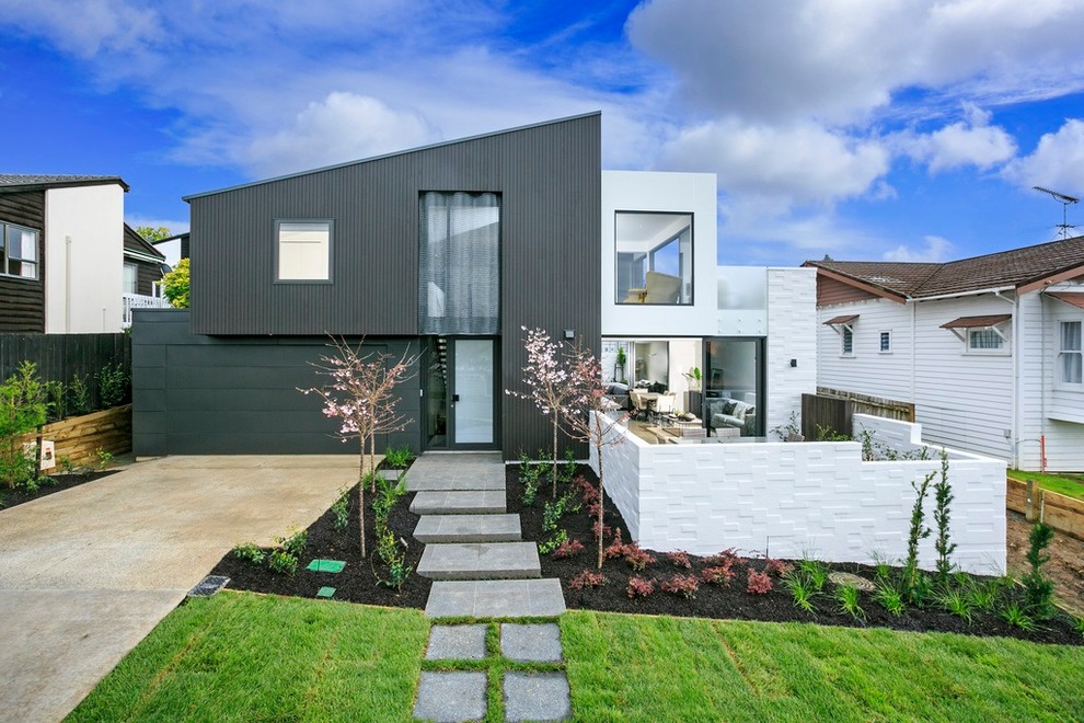 Large contemporary two-storey grey house exterior in Wellington with mixed siding.