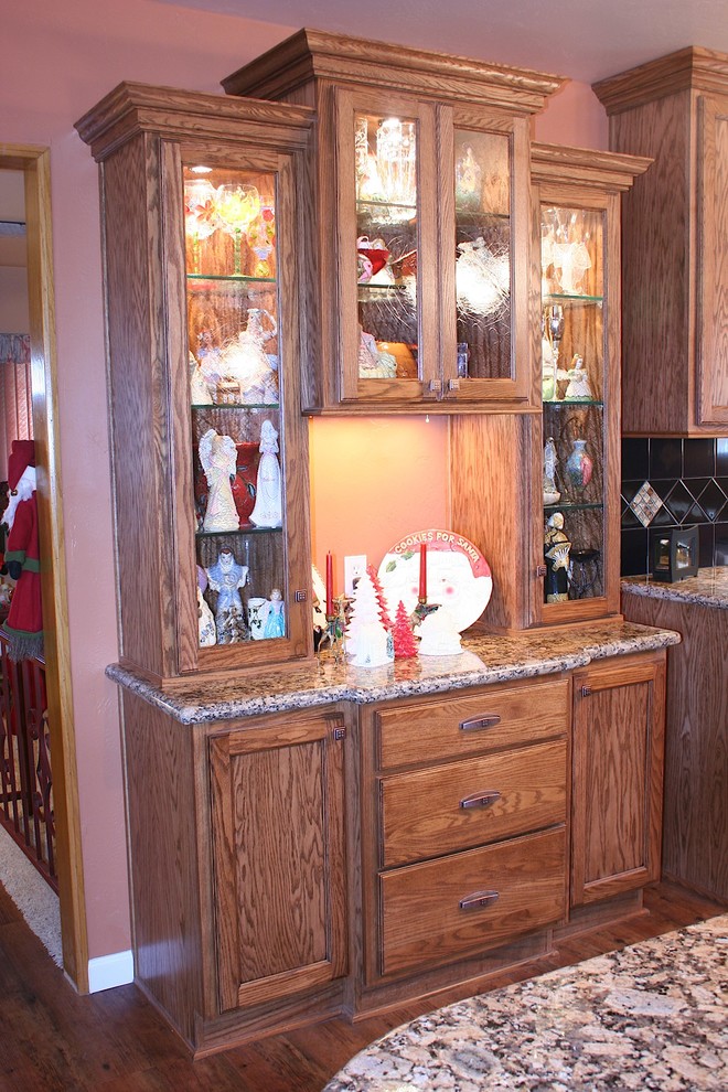 Example of a large classic u-shaped vinyl floor kitchen design with an undermount sink, recessed-panel cabinets, medium tone wood cabinets, granite countertops, black backsplash, ceramic backsplash, stainless steel appliances and an island