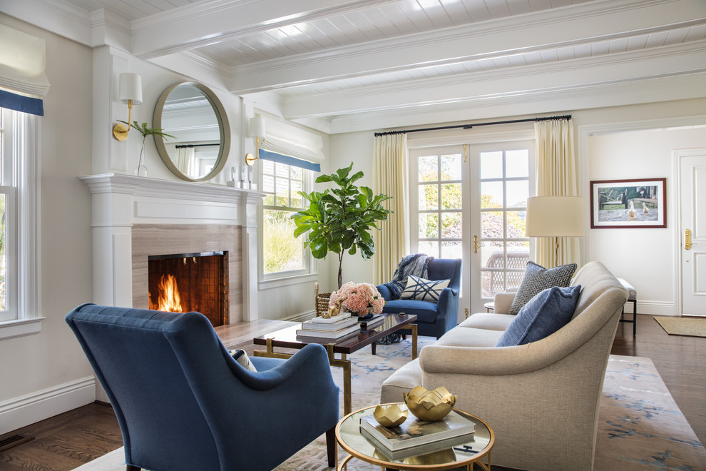 This is an example of a traditional formal open concept living room in San Francisco with white walls, dark hardwood floors, a standard fireplace, a stone fireplace surround and no tv.
