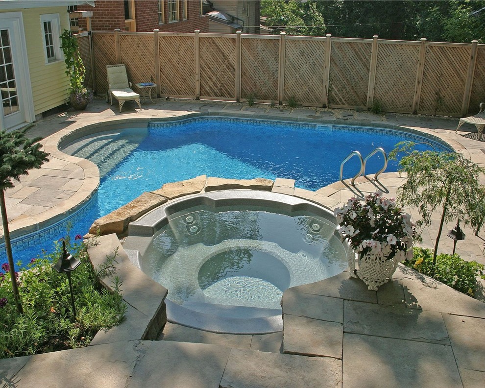 Small contemporary backyard custom-shaped pool in Toronto with a hot tub and natural stone pavers.