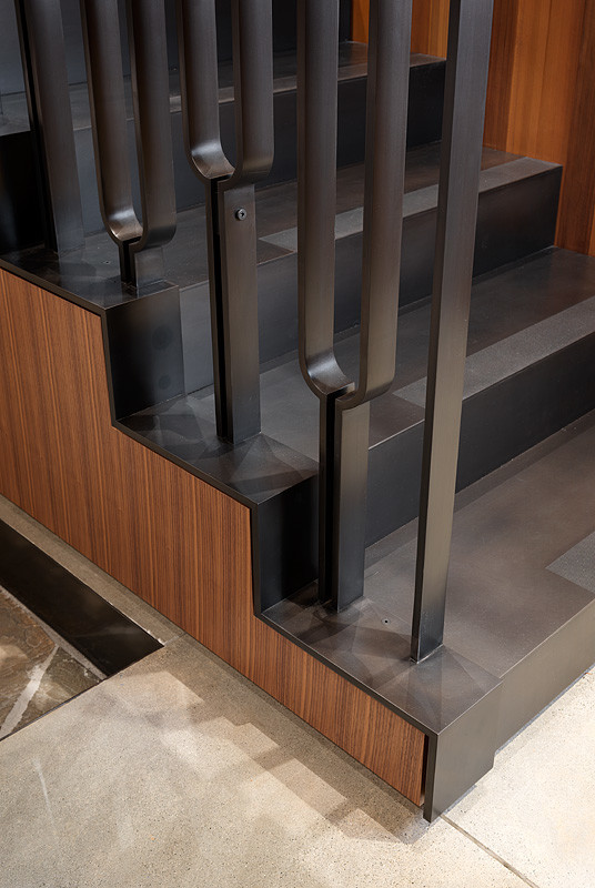 This is an example of a modern metal u-shaped staircase in Seattle with metal risers.