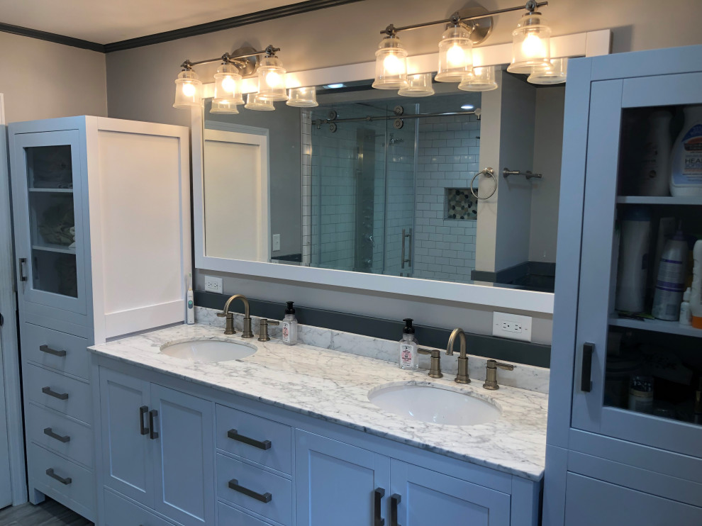 Example of a master bathroom design with granite countertops and multicolored countertops