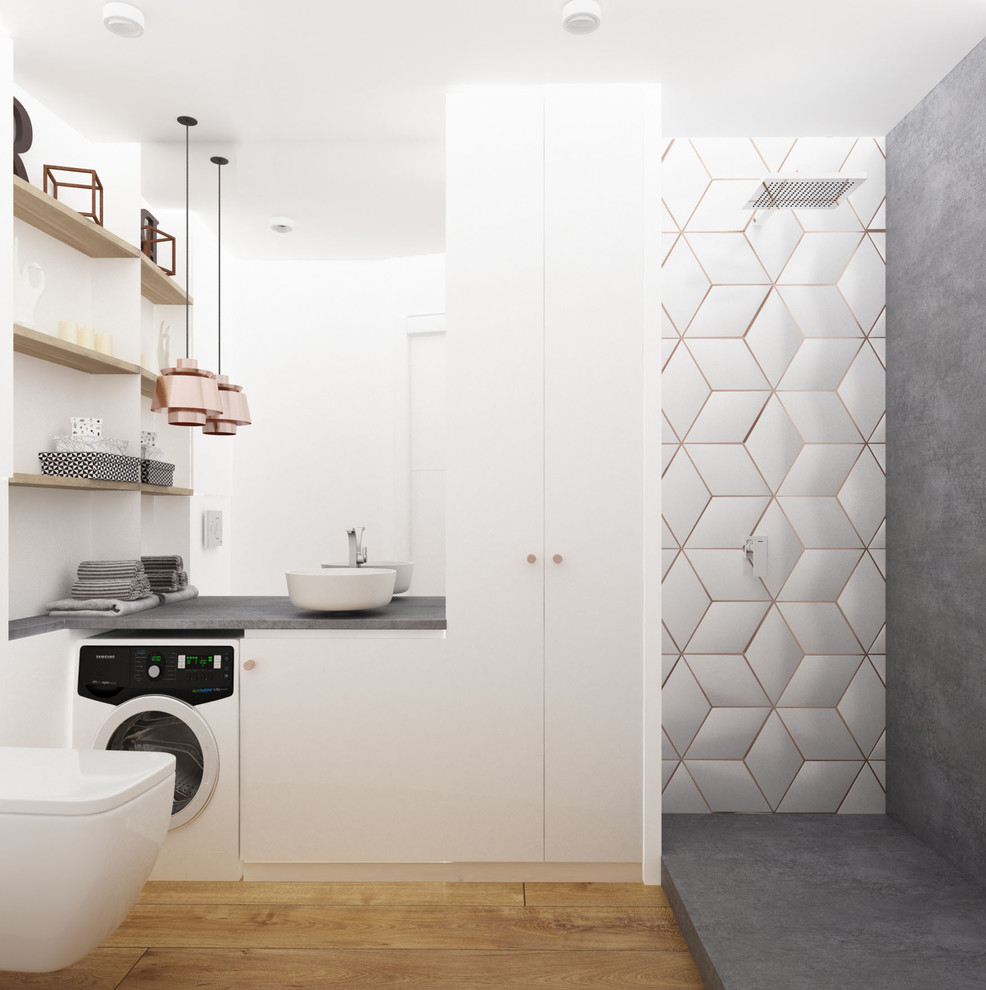 This is an example of a small traditional 3/4 bathroom in Paris with flat-panel cabinets, white cabinets, a curbless shower, a wall-mount toilet, white tile, cement tile, white walls, light hardwood floors, a drop-in sink, concrete benchtops and an open shower.